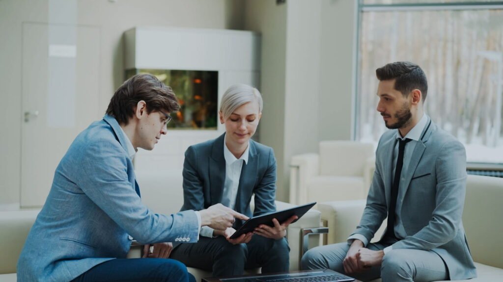 Three business professionals reviewing a document together